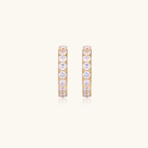 Gold pavé hoop earrings with two freshwater pearls nestled inside the curved design, featuring crystal-studded outer edge.